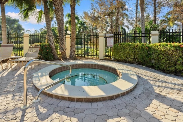 view of swimming pool featuring a community hot tub and a patio area