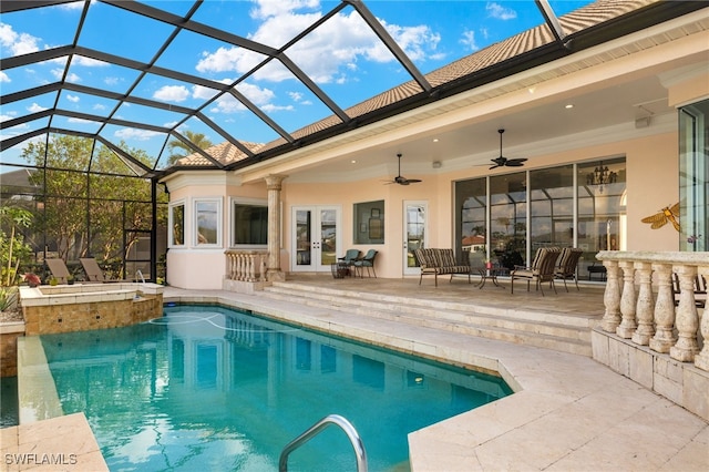 view of pool with glass enclosure, ceiling fan, french doors, and an in ground hot tub