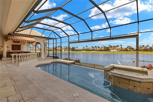 view of pool with glass enclosure, a patio area, a water view, and an in ground hot tub