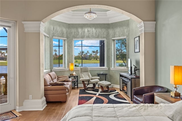 bedroom with hardwood / wood-style floors, a chandelier, and ornamental molding