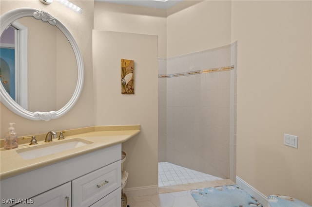 bathroom featuring tile patterned floors, vanity, and tiled shower