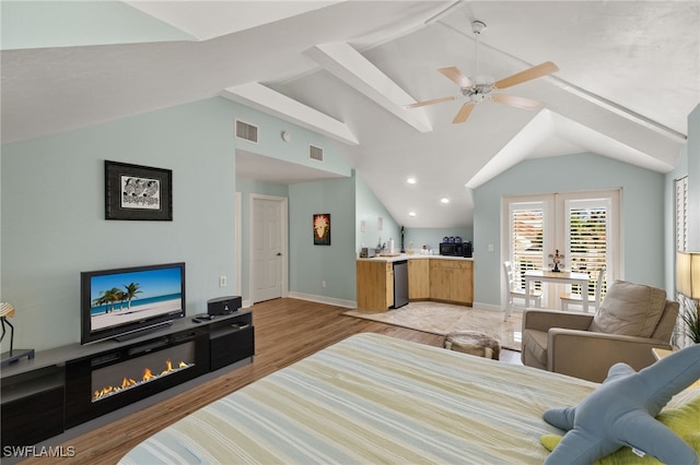 bedroom featuring ceiling fan, light hardwood / wood-style floors, and lofted ceiling