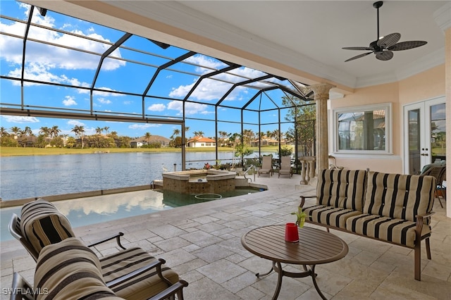 view of patio with ceiling fan, a pool with hot tub, a lanai, an outdoor hangout area, and a water view