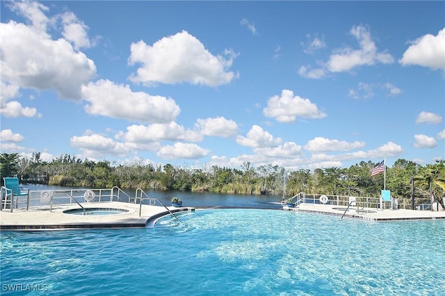 view of swimming pool featuring a water view