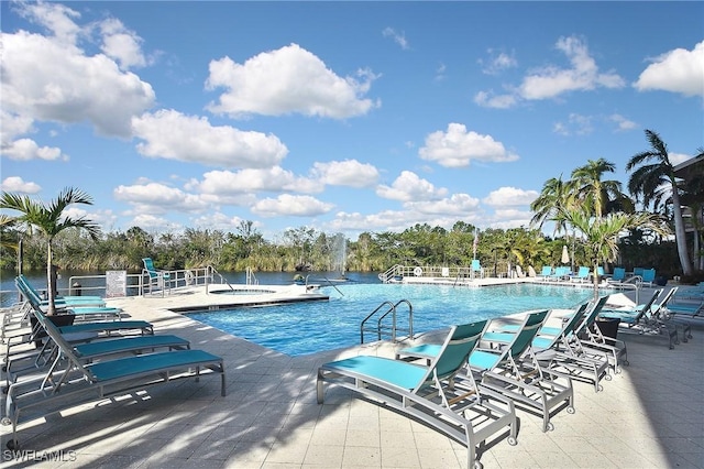 view of pool with a water view and a patio area