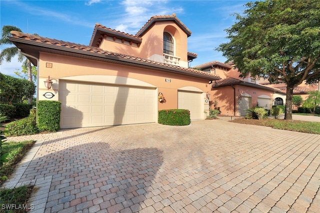 mediterranean / spanish-style house with a garage