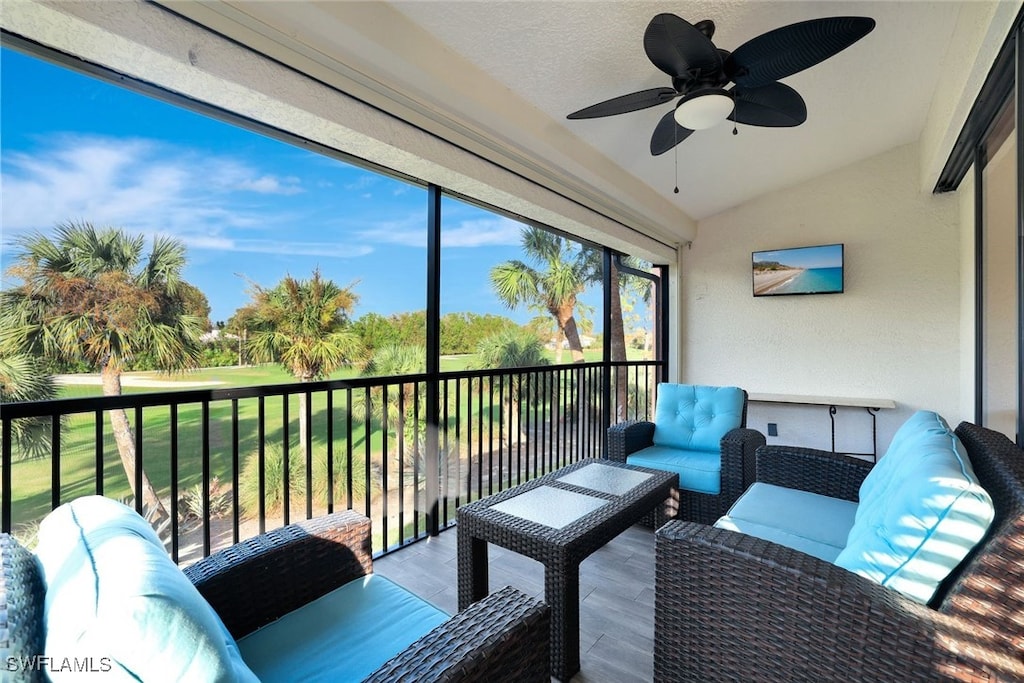 sunroom / solarium featuring ceiling fan and lofted ceiling