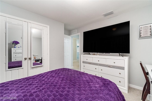 carpeted bedroom with a closet and french doors