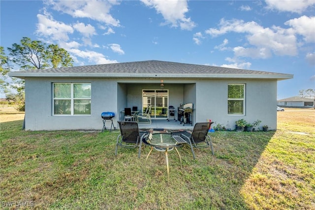 rear view of house with a patio area and a yard