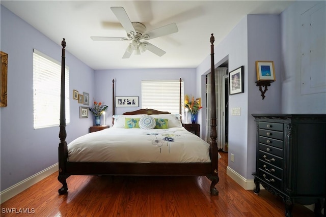 bedroom featuring electric panel, ceiling fan, and hardwood / wood-style floors