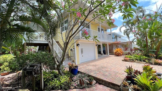 view of front of property with a garage and a balcony