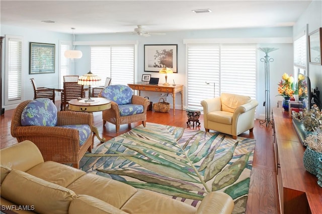 living room featuring a healthy amount of sunlight, ceiling fan, and wood-type flooring