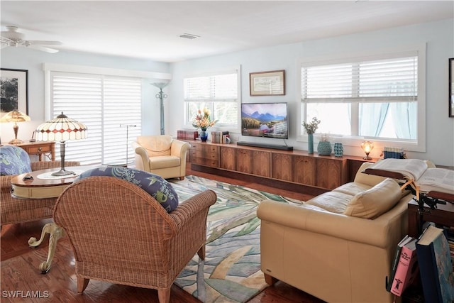 living room with ceiling fan, hardwood / wood-style floors, and plenty of natural light