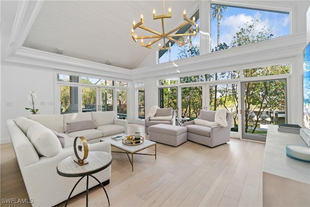 sunroom featuring a notable chandelier, lofted ceiling, wooden ceiling, and french doors