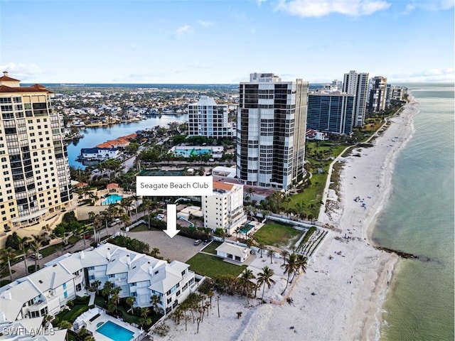 drone / aerial view with a water view and a beach view