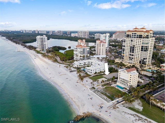 drone / aerial view featuring a water view and a beach view