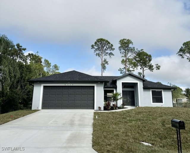 view of front of home with a garage and a front yard