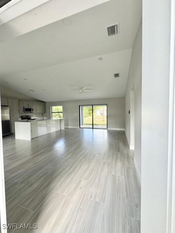 unfurnished living room featuring sink