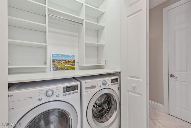 laundry room with washer and dryer, laundry area, baseboards, and marble finish floor