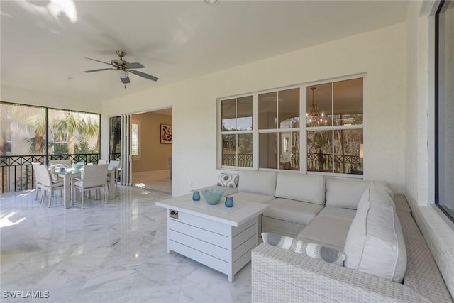 sunroom with a ceiling fan