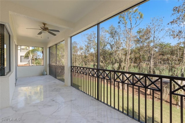 unfurnished sunroom with beam ceiling and ceiling fan