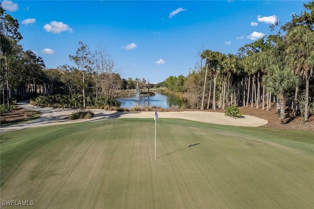 view of home's community with a water view and view of golf course