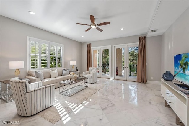 living room featuring recessed lighting, a healthy amount of sunlight, french doors, and marble finish floor