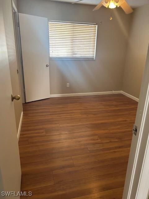 spare room featuring dark hardwood / wood-style floors and ceiling fan