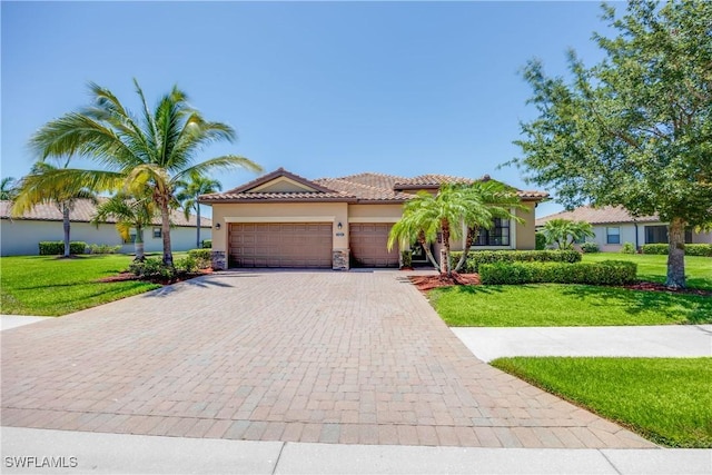 mediterranean / spanish-style house featuring a front yard and a garage