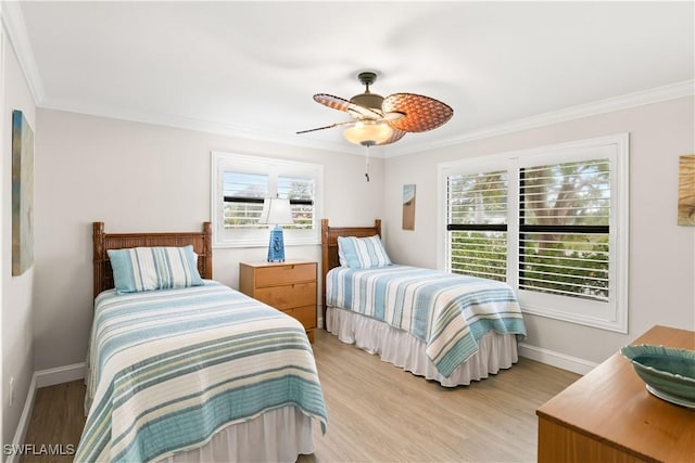 bedroom featuring ceiling fan, crown molding, and light hardwood / wood-style flooring