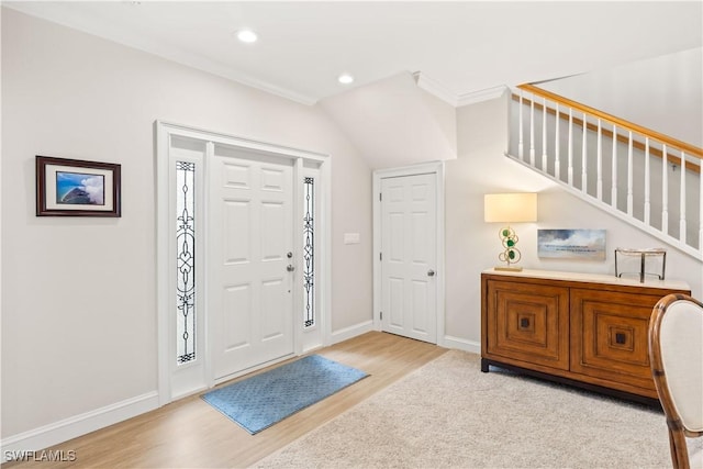 entryway featuring light hardwood / wood-style floors and crown molding