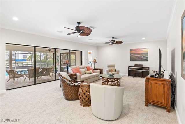 living room featuring ceiling fan, ornamental molding, and light carpet