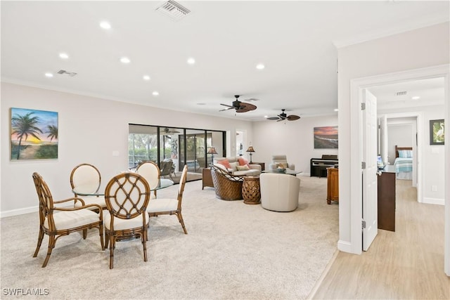 dining room with light hardwood / wood-style flooring and ceiling fan