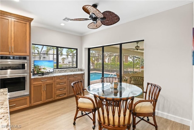 dining room featuring ceiling fan, light hardwood / wood-style floors, and ornamental molding