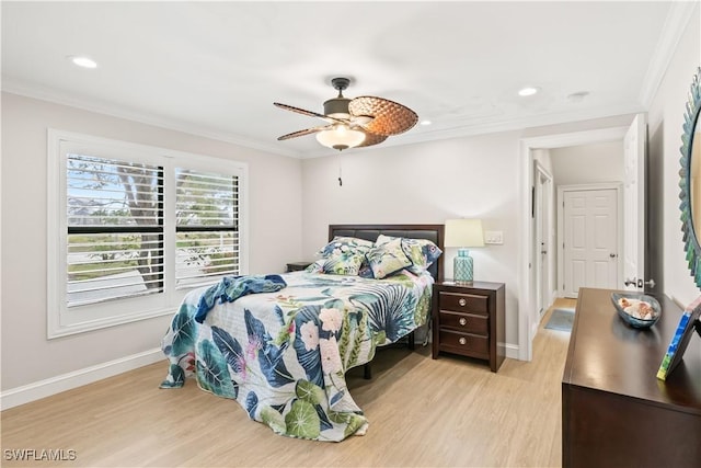 bedroom featuring ceiling fan, ornamental molding, and light hardwood / wood-style flooring