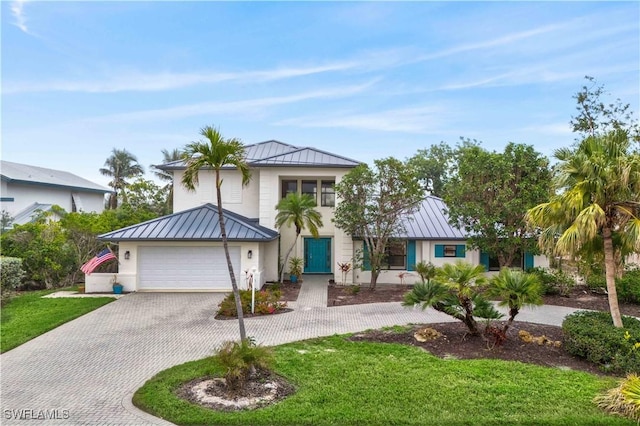 view of front of house featuring a garage and a front yard