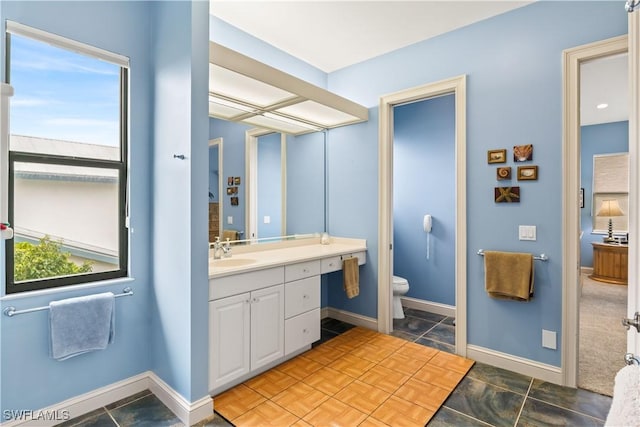 bathroom featuring vanity and toilet