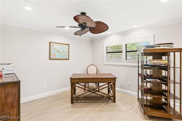 office space featuring ceiling fan, ornamental molding, and light wood-type flooring