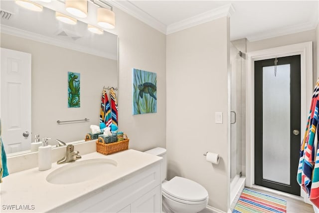 bathroom with vanity, toilet, crown molding, and walk in shower