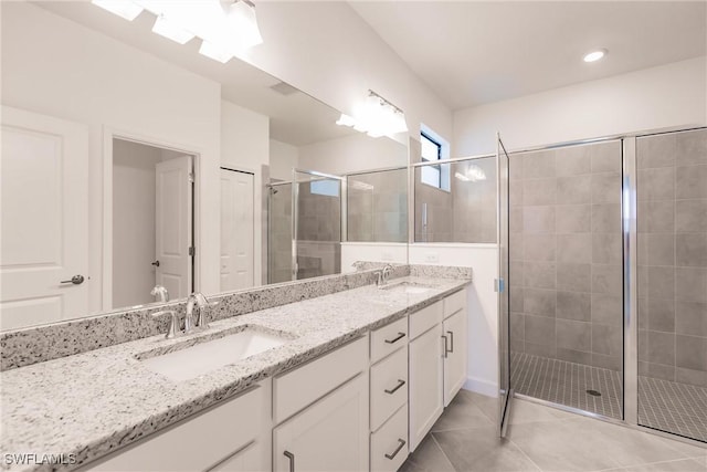 bathroom with tile patterned flooring, vanity, and an enclosed shower