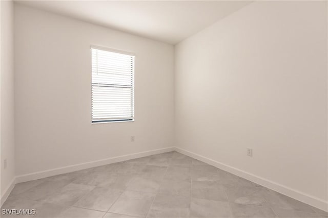 spare room with light tile patterned flooring