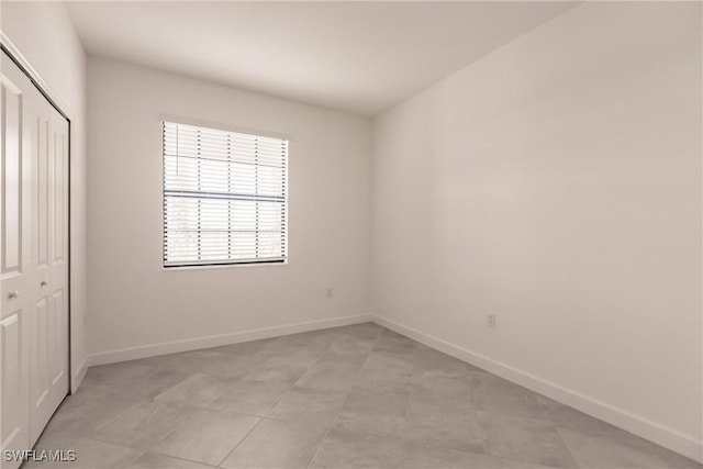 unfurnished bedroom with a closet and light tile patterned floors