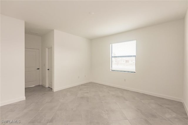 unfurnished room featuring light tile patterned floors