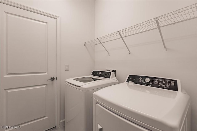 laundry area with washing machine and dryer