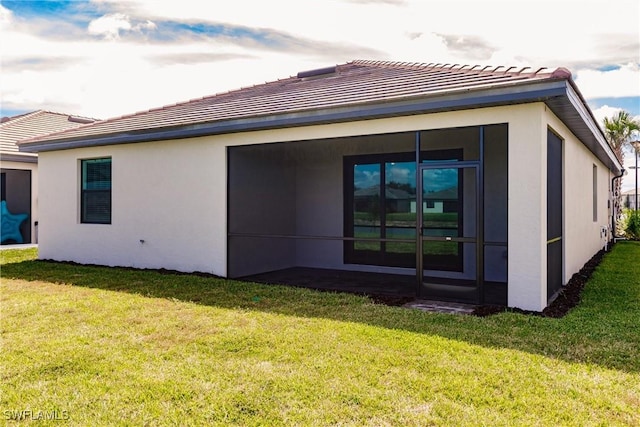 rear view of property with a yard