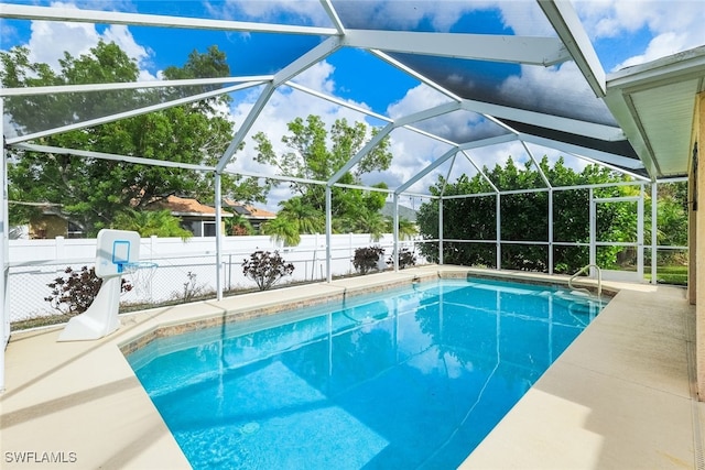 view of pool with a patio and a lanai