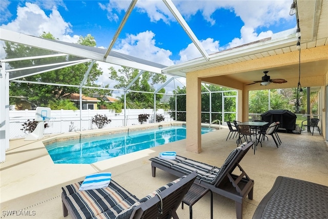 view of swimming pool with ceiling fan, a lanai, a patio, and grilling area