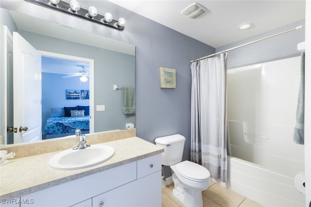 full bathroom featuring vanity, ceiling fan, shower / bath combo with shower curtain, tile patterned flooring, and toilet