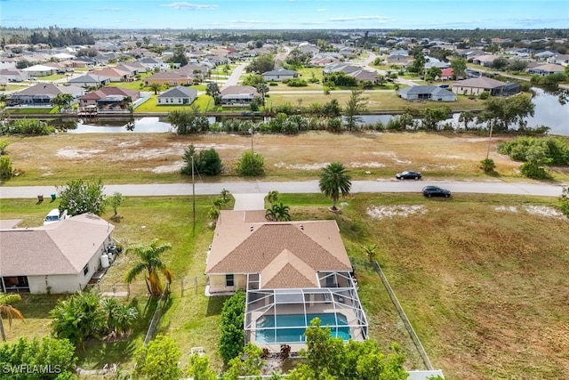 birds eye view of property featuring a water view