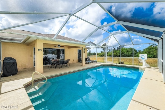 view of pool with a patio, area for grilling, ceiling fan, and a lanai